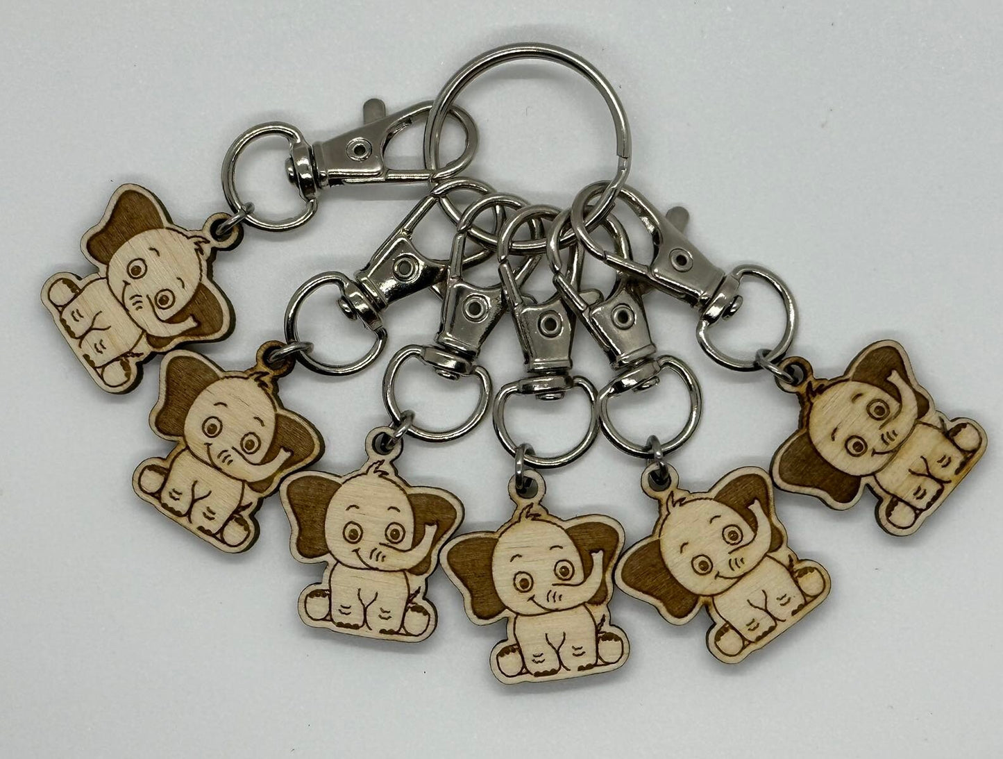 Keychain with multiple small elephant charms on a white background