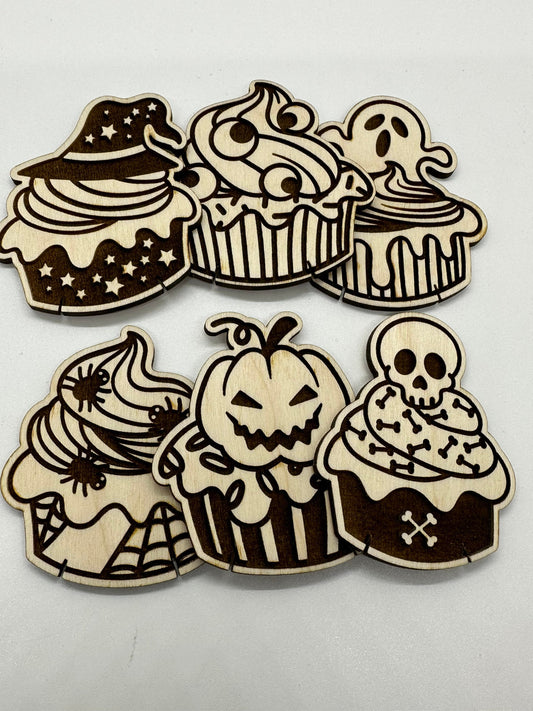 Set of Halloween-themed wooden cupcake cutouts on a white background