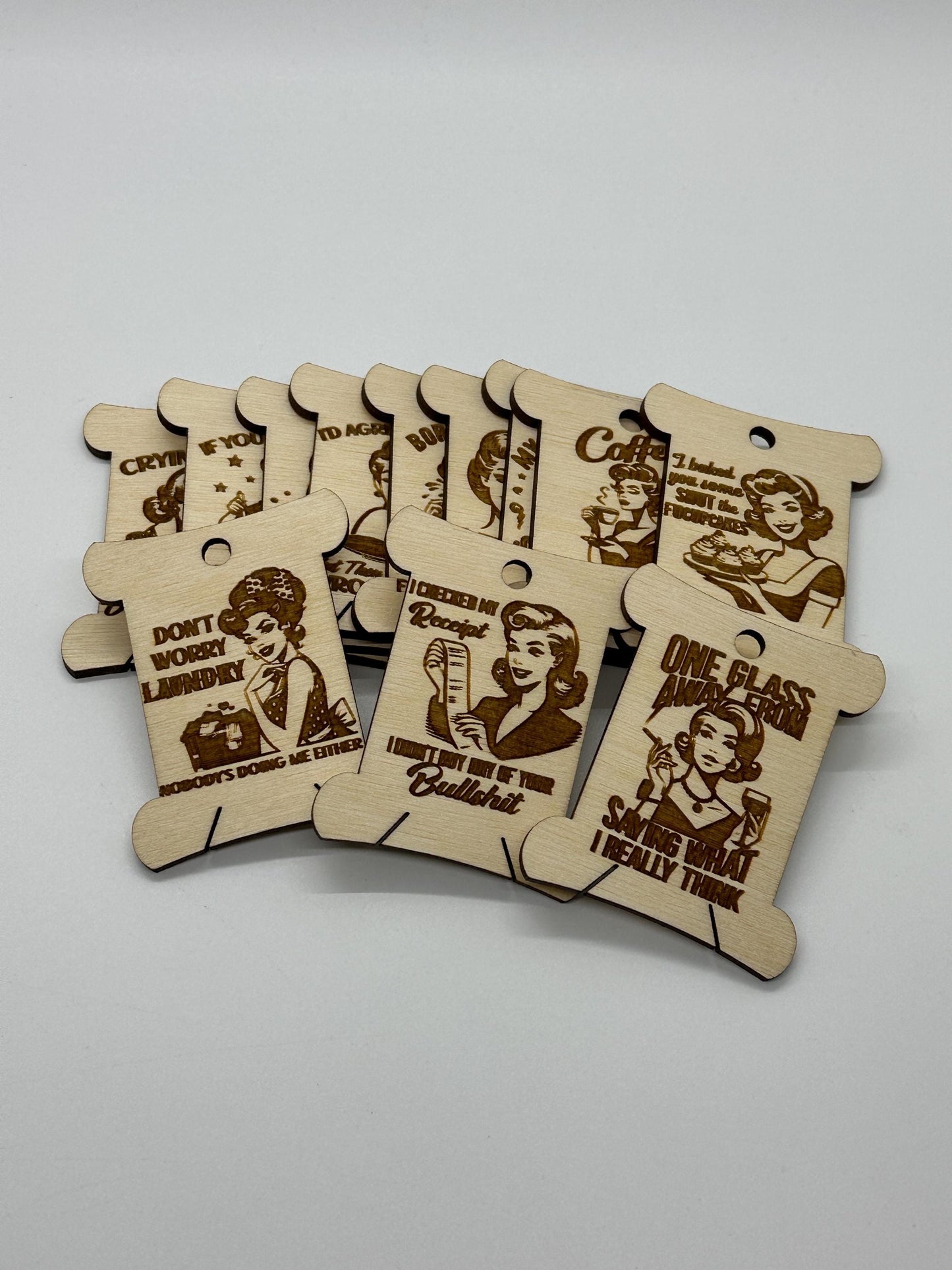 Set of wooden tags with engraved text and illustrations on a gray background