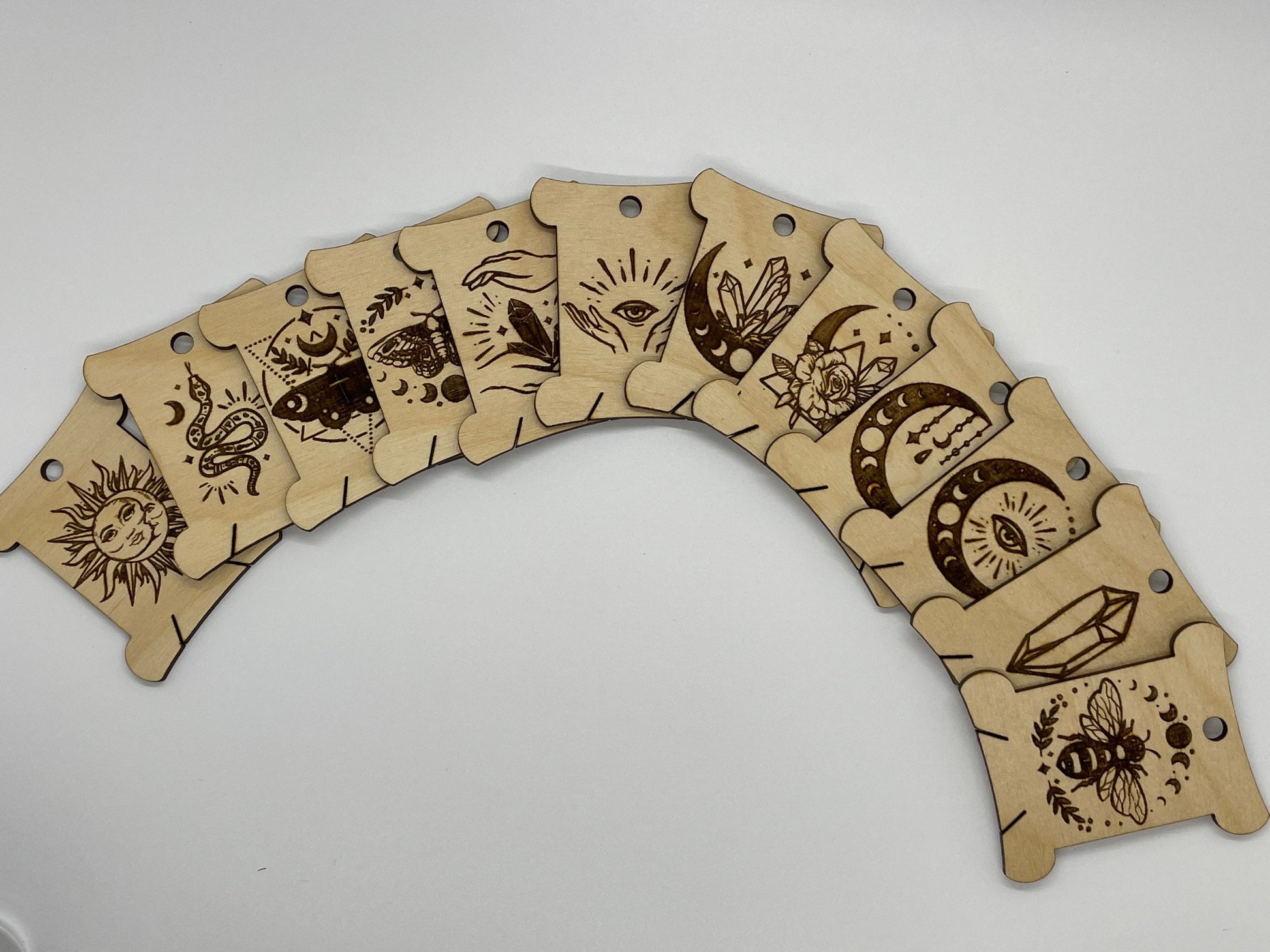 Arch-shaped wooden product with laser-cut designs on a white background