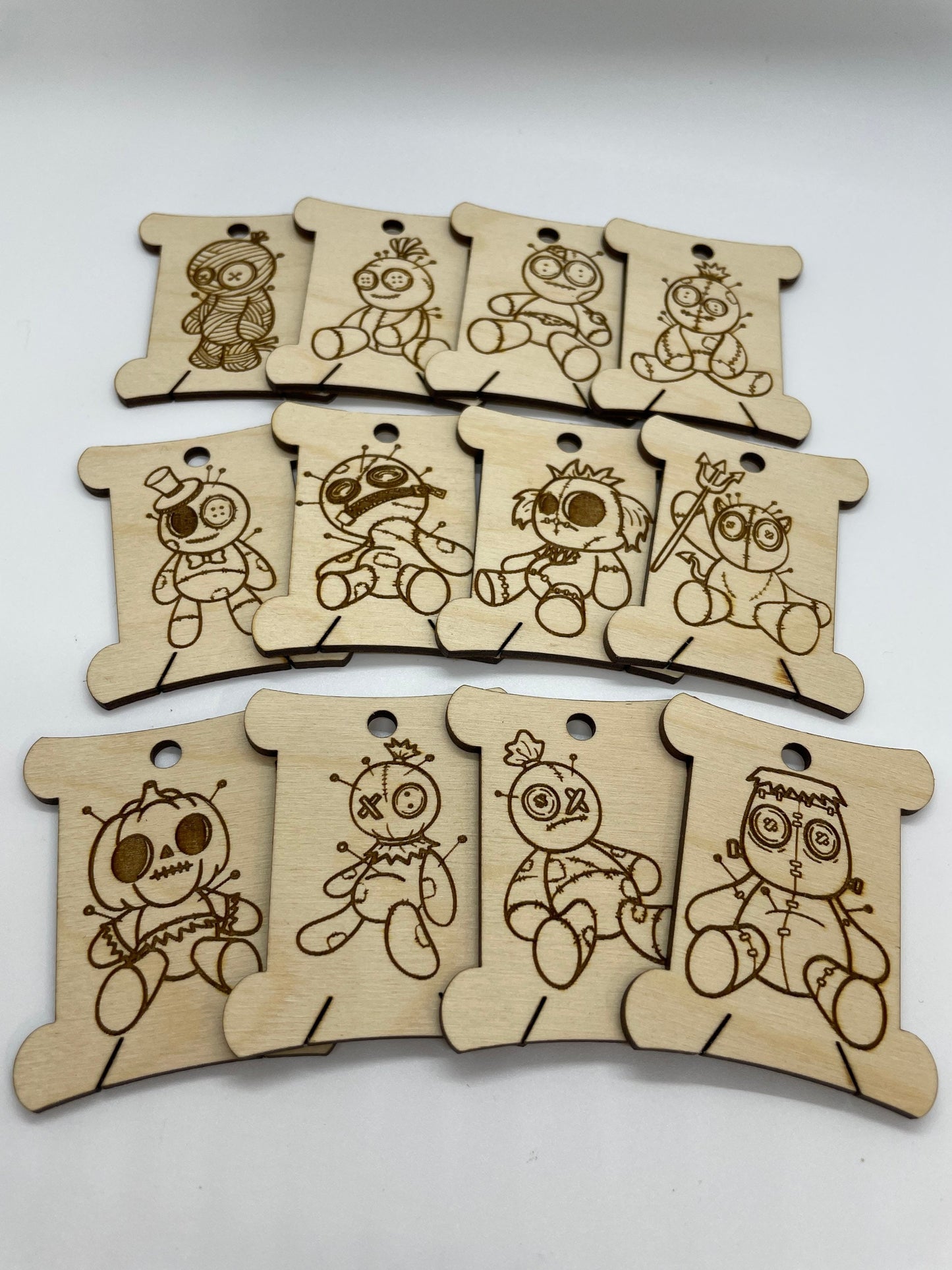 Set of wooden tags with engraved cartoon characters on a white background