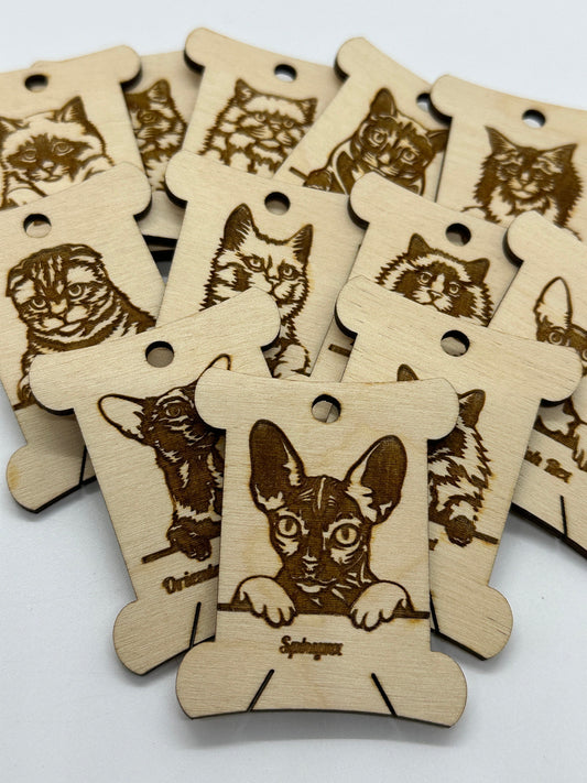 Wooden tags with engraved cat and cat illustrations on a white background