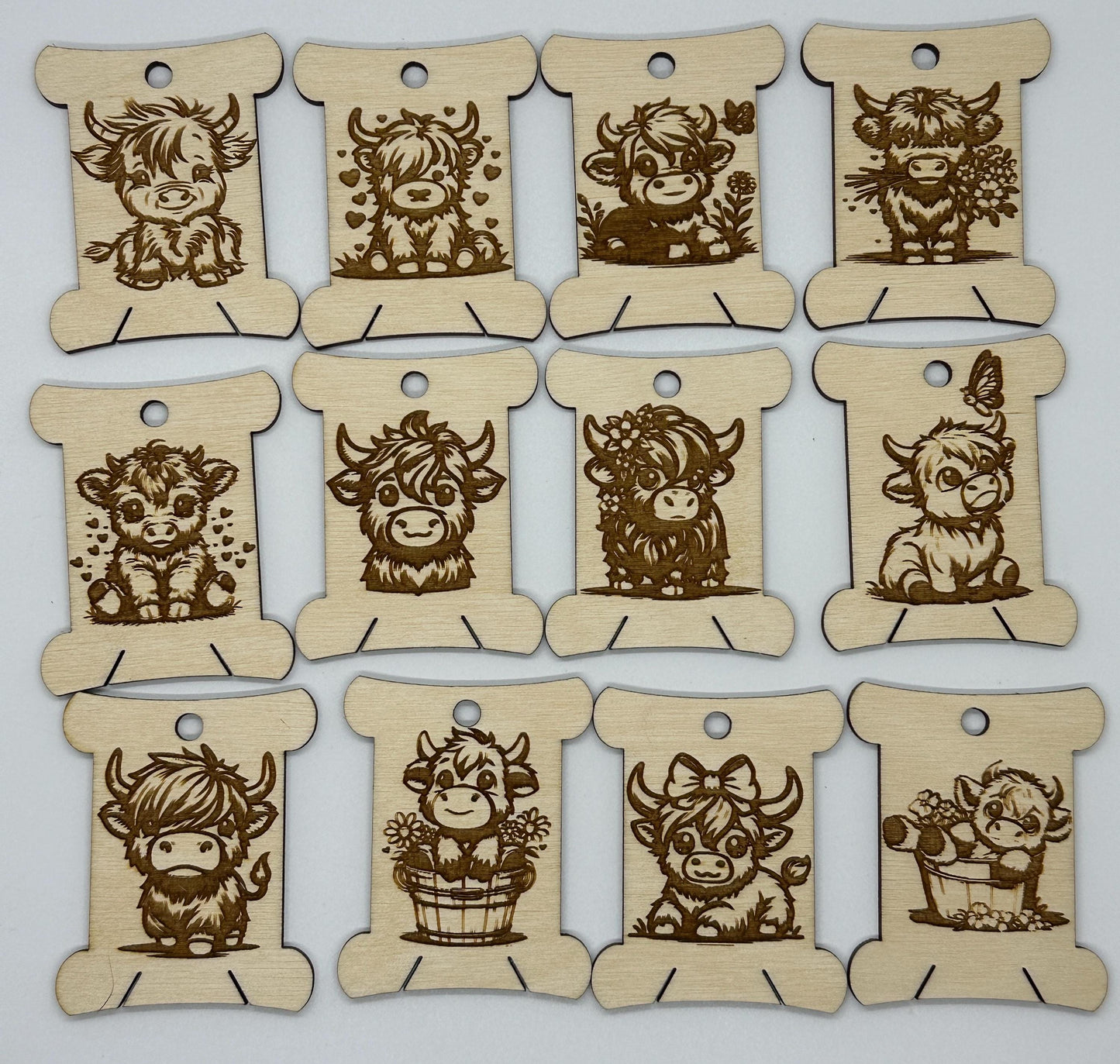 Set of wooden tags with engraved cow designs on a white background