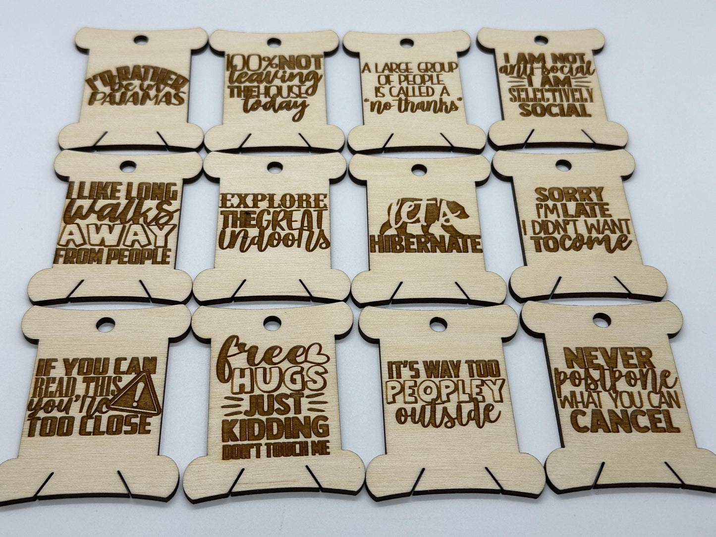 Set of wooden tags with humorous sayings on a white background
