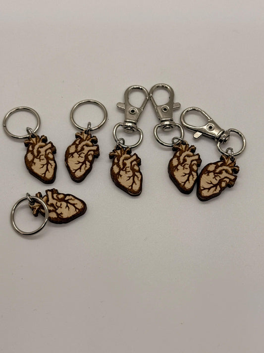 Set of anatomical heart keychains on a white background